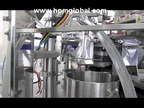 Preformed pouch fill and seal machine with cup conveyor and liquid filler