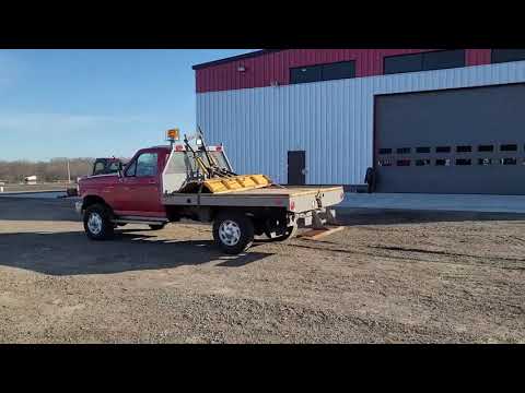 Lot 596, 1997 Ford F350 flat bed pickup with snow plow