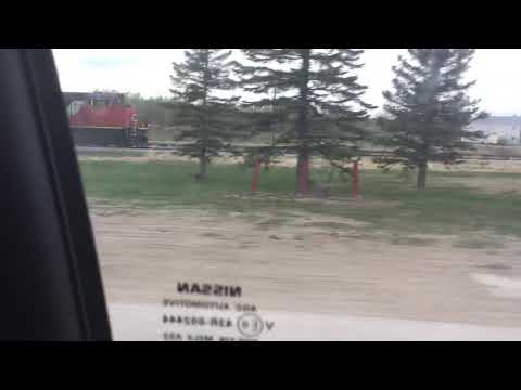 CN SD70M-2 leading a grain train with another Kyle grain car
