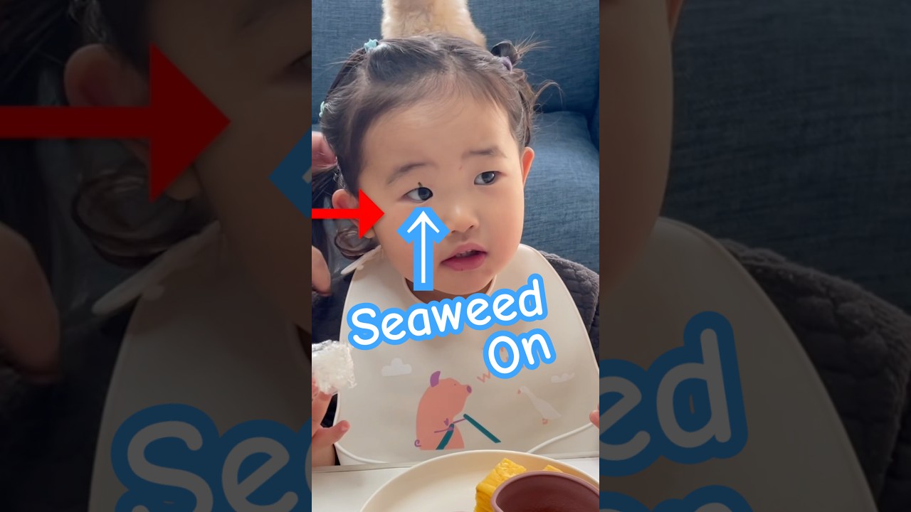 She got seaweed stuck on her face 😂🍙 (and keeps eating) #babyfood