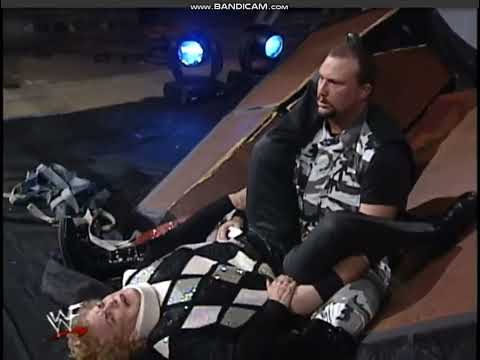 Bubba Ray Dudley powerbombs Mae Young off stage through multiple tables