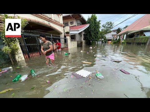 Typhoon kills 2, traps people on roofs and submerges cars in central Philippines