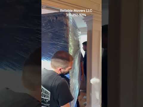 Reliable Movers moving heavy Stickley furniture during an Oswego NY local move