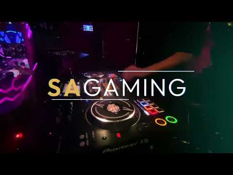 SA Gaming’s 17th anniversary celebration highlight video in Kuala Lumpur, featuring a nighttime city skyline, neon dragon and lion dances, a DJ, a festive party venue, and the message “Thanks for celebrating with us!”