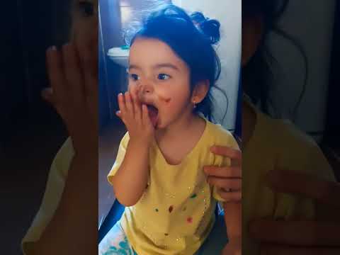 Alisa eats chocolate and rubs it on her face