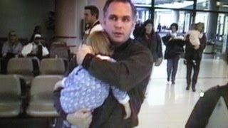 GARTH BROOKS carries his child through airport