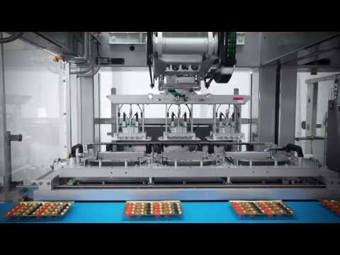 , title : 'Fully automatic packaging line from Schubert: Robots place sweets in plastic trays'