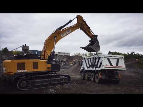 CASE CX750D excavator loading basalt in ASTRA HHD9 dump truck