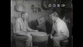 Hugh Tracey doing what he loved the most, showing off his collection of African instruments