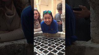 me singing into a well in italy