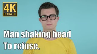 Man shaking head to refuse blue background.