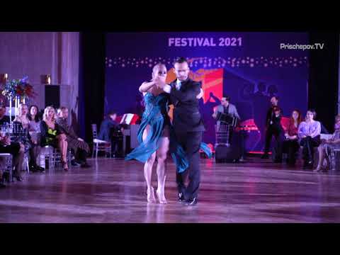  Liza Rosales  and  Juan Manuel Rosales  are  dancing  to  the  tango  "  A Evaristo Carriego  "  by  Solo Tango Orquesta  at  La Boca Tango Festival  in  2021
