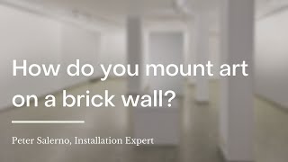 How do you mount art on a brick wall?