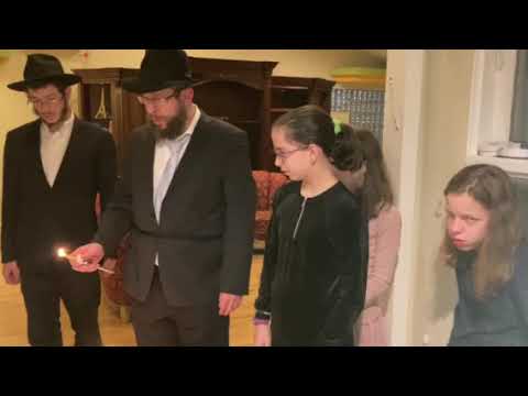 Rabbi Kramer sings the 2nd blessing on the Menorah