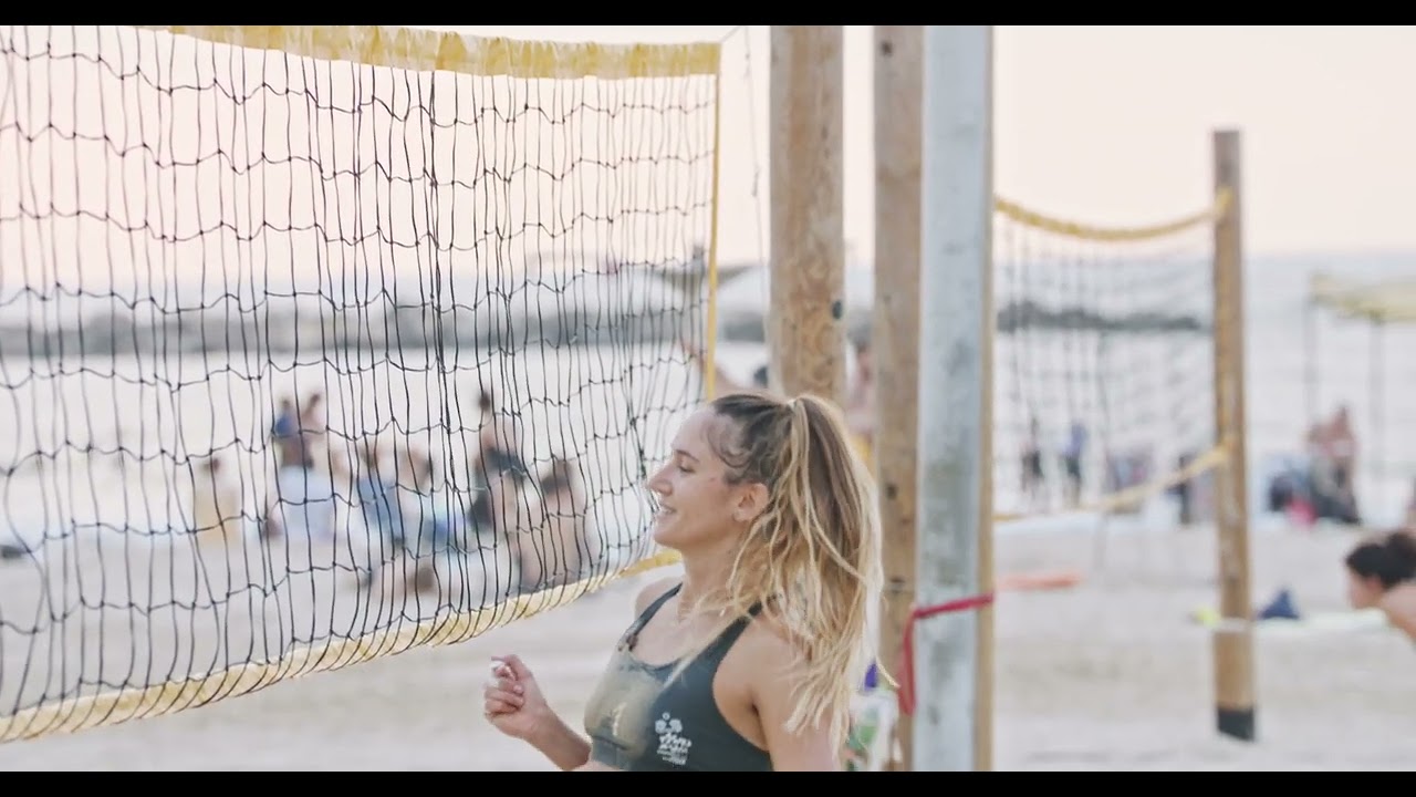 Volleyball Player Hitting A Ball Over The Net During A Game On A Beach   Stock Video Footage