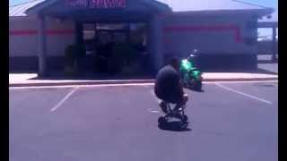 Big Dude On Tiny Bike in Front of Family Pawn