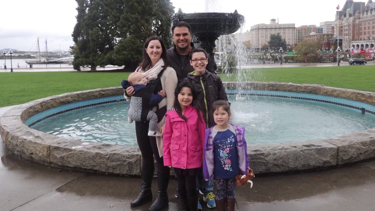 Colton with his family in front of a fountain