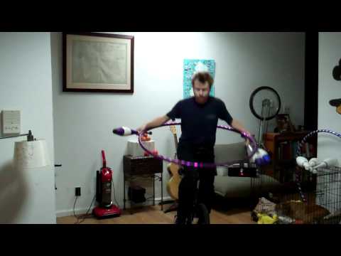 Insane multitasking! Unicycle, hula hoop, juggling.