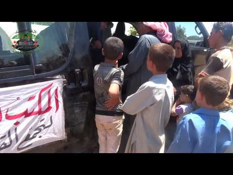 المكتب الإغاثي في تجمع القادسية يقوم بتوزيع الحليب للعائلات النازحة من ريف حماة الشمالي في قرية الشريعة