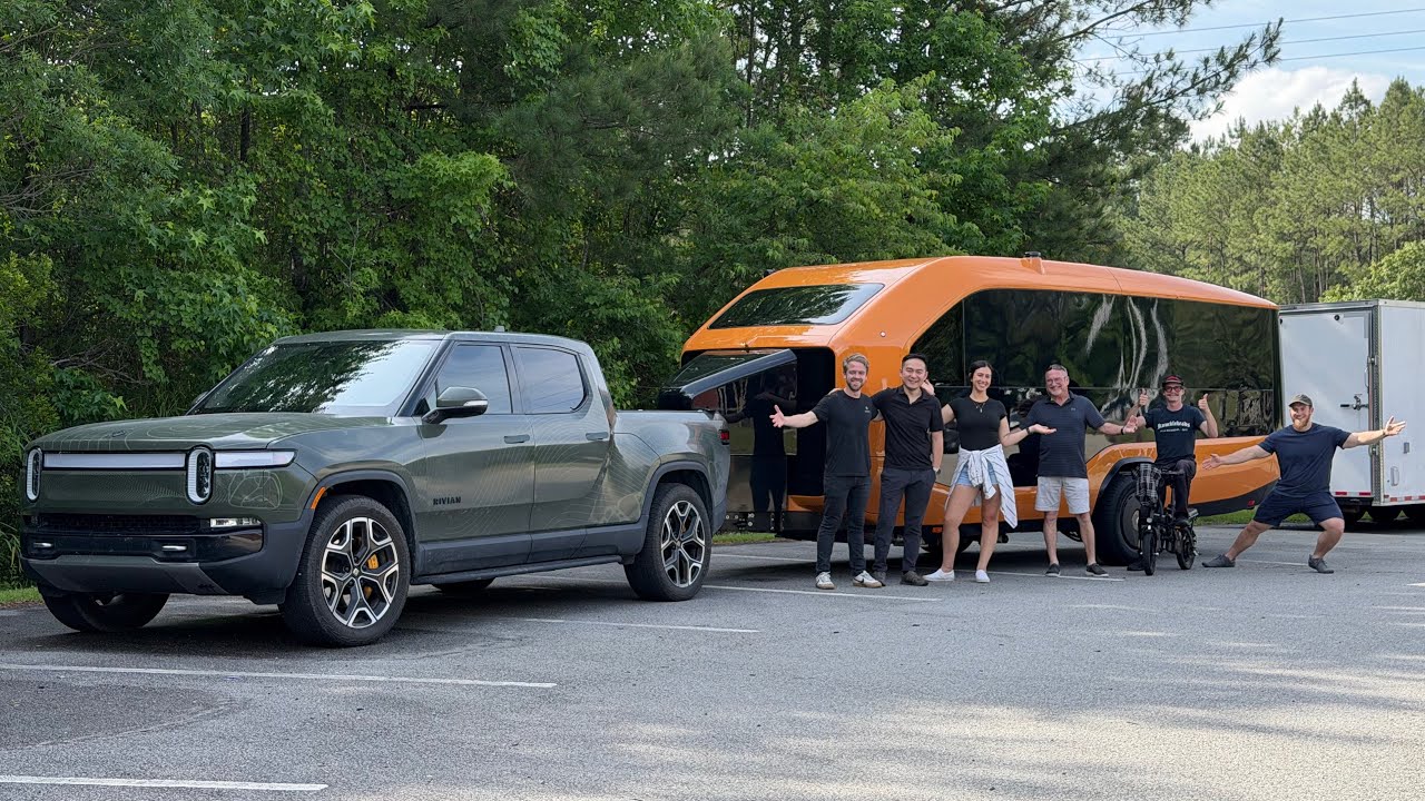 Pebble Flow electric travel trailer in orange parked at the Out of Spec Reviews facility