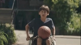 Kids playing basketball open their hearts and invite a boy in a wheelchair to play