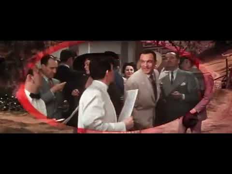 Trailer shot: villagers gathered for the wedding as the reel kicks up