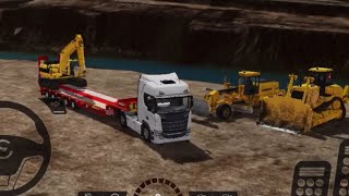 Car Truck with long trailer transport excavator to working area.