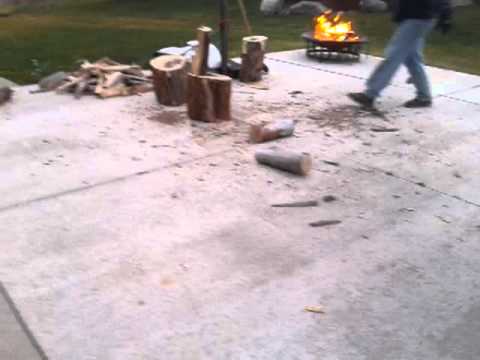 Man cuts wood and breaks ax and his hand