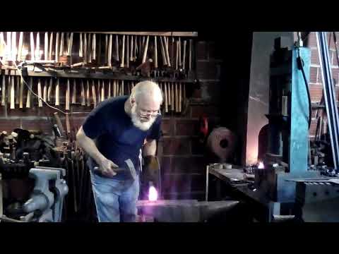 Blacksmith demo of hot cutting a 1" square bar