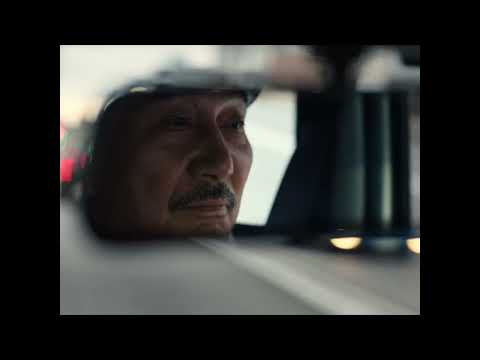 Perfect Days trailer still — Hirayama driving his van at dawn with cassette deck glowing