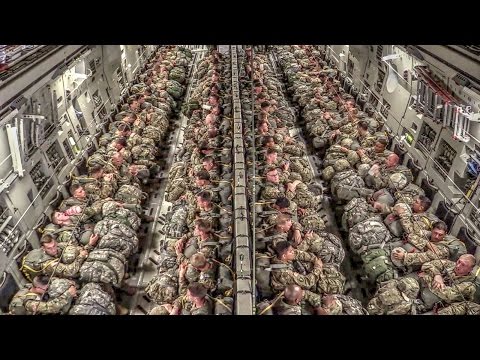 Watch Hundreds Of Paratroopers Jump Out Of An Airplane In Formation