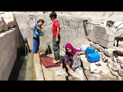 The nomadic life of Ferishte, Ali Akbar and Fariba, watering the flock in the head of the spring