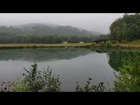 Brief overview of the pond. The grassy strip on this side is the back side of campsites 4-9. There's an airstrip on the far side. If you look closely, you'll see a plane under the shelter. Fishing for catfish and trout is possible without a license on this private pond.