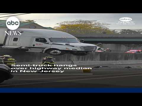 Semi-truck hangs over highway median in New Jersey