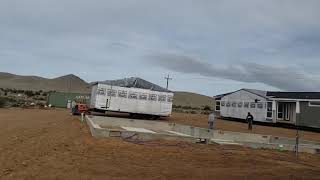 Watching a modular home get set on foundation.