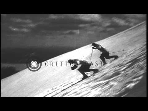 Men sliding downhill and demonstrating the jump turns and terrain turns in the Un...HD Stock Footage