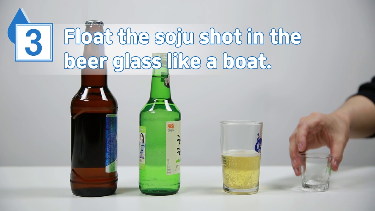 Korean somaek cocktail being mixed in a beer glass with a shot of green bottle soju showing the classic preparation