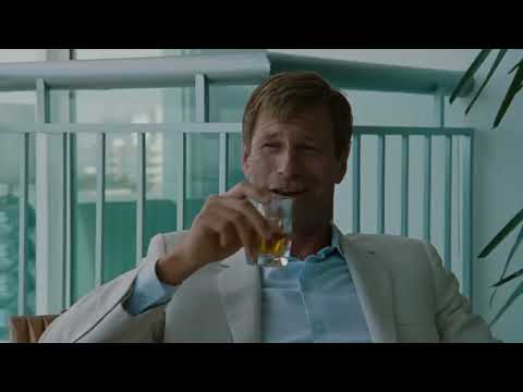 Trailer collage — neon streets, a yacht deck, and a newsroom argument, all snapping to drums and horns