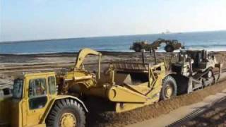 CAT D8R push loading 637E’s with sand
