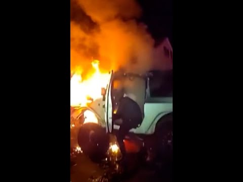 Trapped driver rescued from burning car