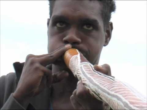 Elijah Wunungmurra playing a yirdaki made and painted by Batumbil Burarrwanga