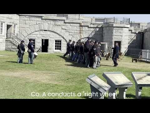 Civil War re-enactors practice close-order infantry drill at historic fort