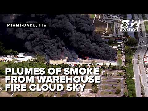 Massive warehouse fire is sending thick black smoke in Miami Gardens