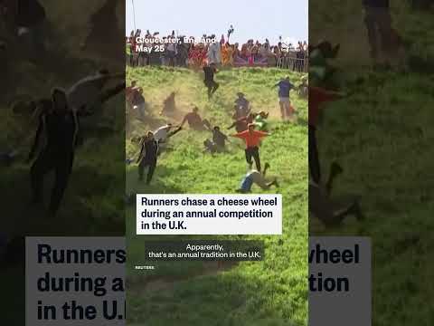 Runners chase a cheese wheel during an annual competition in the U.K.
