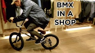 Riding BMX in a clothes store