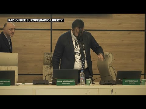 Georgian opposition member splashes black liquid over electoral commission chair | AFP