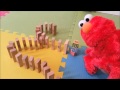 Elmo Knocks Over Dominos