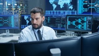 In the System Control Center Technical Operator Monitors Displays at His Workstation. | Stock