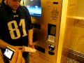Buying gold in a vending machine in Abu Dhabi at Emirates palace!