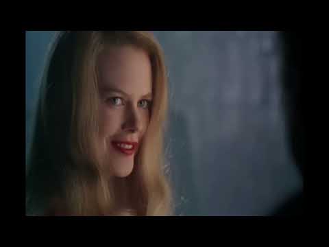 Batman Forever trailer moment: Gotham skyline bathed in neon greens and purples